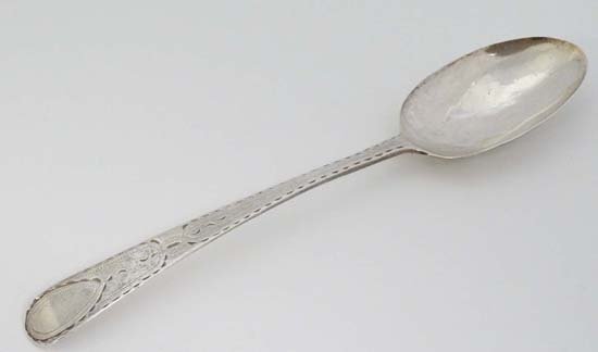 A Geo III silver table spoon with bright cut: A Geo III silver table spoon with bright cut decoration. Hallmarked Exeter 1784 maker Joseph Hicks 8" long (44g)