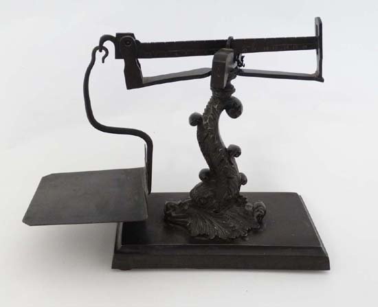 An extremely rare example of an early to mid 19thC cast: An extremely rare example of an early to mid 19thC cast bronze beam scale, the central 'pillar' cast in the form of an elaborate fish / Georgian Dolphin with a hinged pan on a flat bronze plinth. Appr
