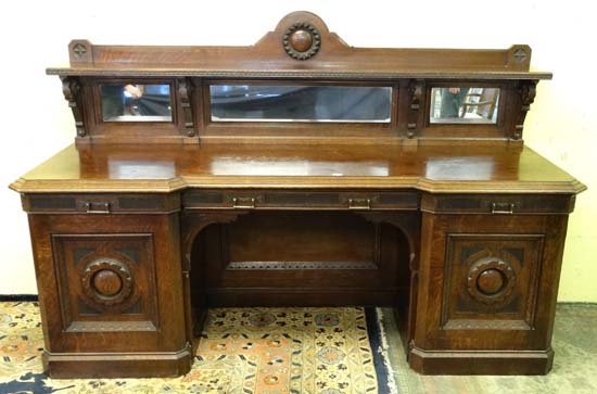 Scottish Arts & Crafts : John Taylor & Son Edinburgh -: Scottish Arts & Crafts : John Taylor & Son Edinburgh - A late 19thC oak inverted break front sideboard with low triple mirrored back, shelf and carving. Signed 94" wide x 57 1/4" high Please Note - we