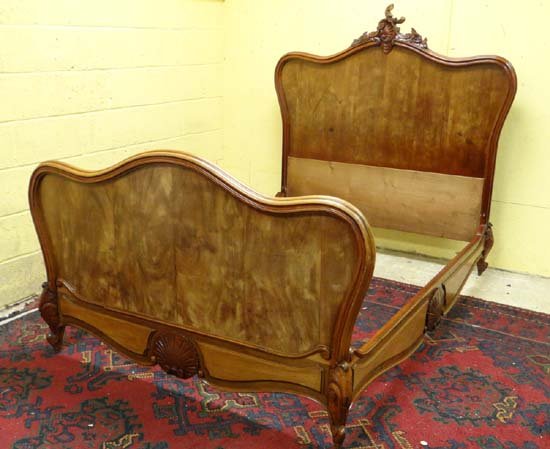 A Louis XV style French Mahogany bed , the side rails: A Louis XV style French Mahogany bed , the side rails with carved Rococo style decoration 52 3/4" long £80 - 120