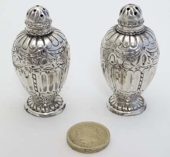 A pair of HM silver pepperettes, London 1886 maker: A pair of HM silver pepperettes, London 1886 maker William Comyns & Sons. Approx 2 1/2" high (48g) £30 - 40