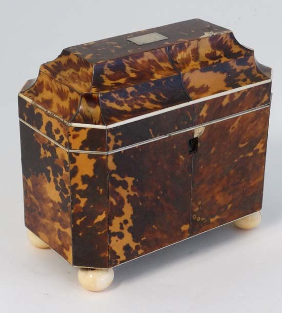 A c1800 tortoiseshell and ivory two sectional tea caddy: A c1800 tortoiseshell and ivory two sectional tea caddy with ivory stringing and facing, silver plate stringing and canted corners. Standing on ivory spherical feet. 7'' wide x 3 7/8'' deep x 6'' high