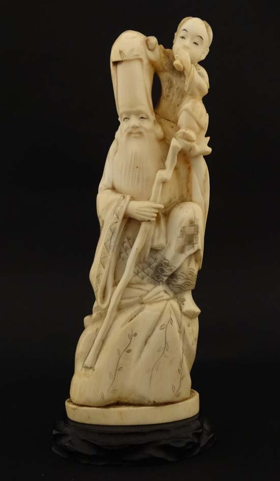 Oriental carved okimono : A signed carving of the deity (1 of 7)