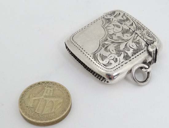 A silver vesta case with engraved decoration, hinged: A silver vesta case with engraved decoration, hinged lid and striker under. Hallmarked Birmingham 1907 maker Joseph Gloster 1 1/4" high (20g)