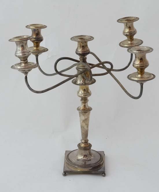 WITHDRAWN FROM AUCTION: WITHDRAWN FROM AUCTIONA silver plate 5 branch candelabra on a squared base with 4 ball feet Approx 19" high