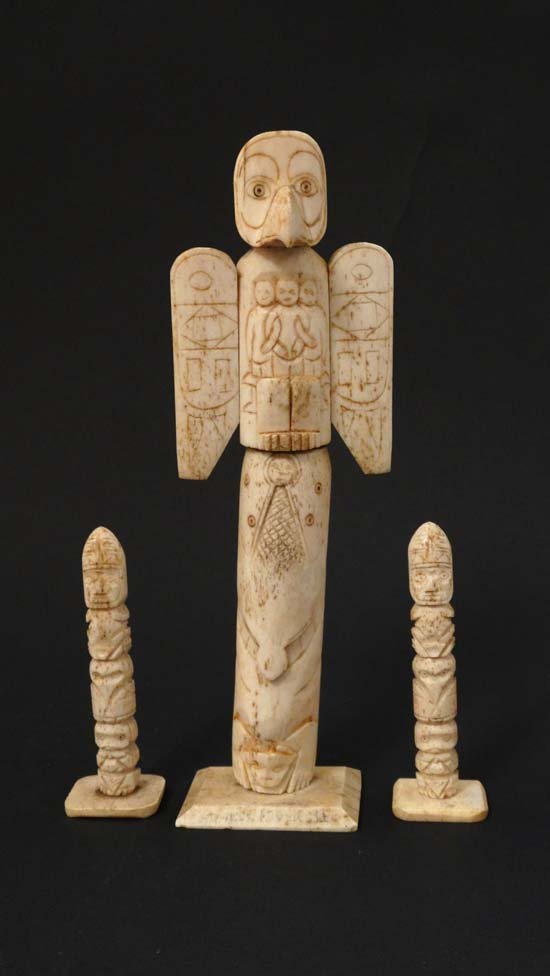 Native American Indian : A C1900 a 3 piece North West: Native American Indian : A C1900 a 3 piece North West Coast Totem set made from carved bone , has image of an eagle, spirit creatures and figures with entwined arms, Buffalo together with a pair of sm