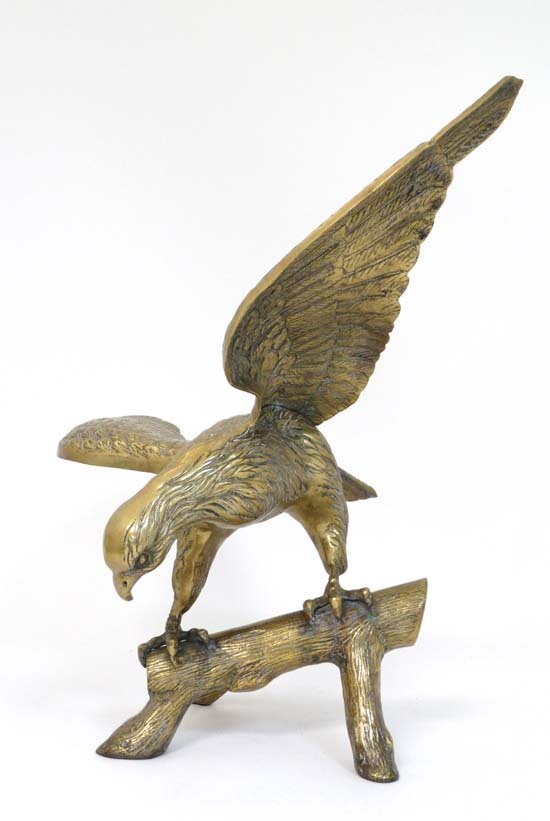 A brass sculpture of an eagle perched on a branch . 21 (1 of 8)