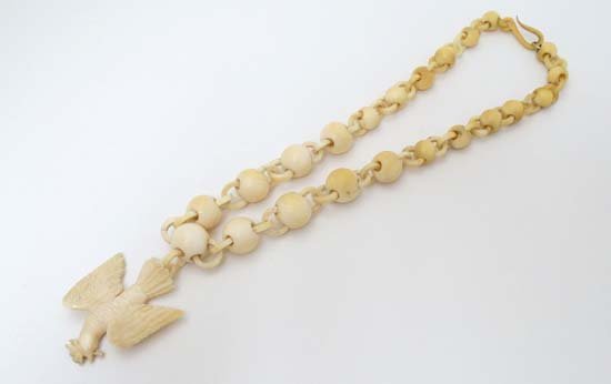 An early 20thC ivory necklace of graduated beads with (1 of 3)