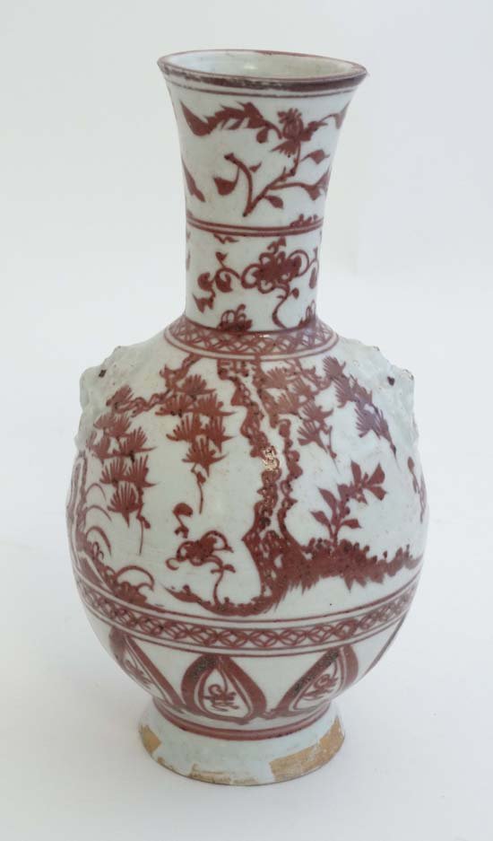 A Chinese iron red and white pottery bottle vase with f (1 of 4)