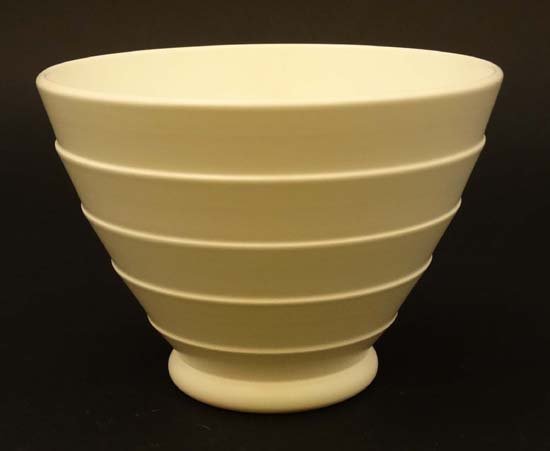 A Keith Murray for Wedgewood '' Moonstone '' bowl in wh: A Keith Murray for Wedgewood '' Moonstone '' bowl in white with banded decoration, having makers stamp to base. 6'' diameter.