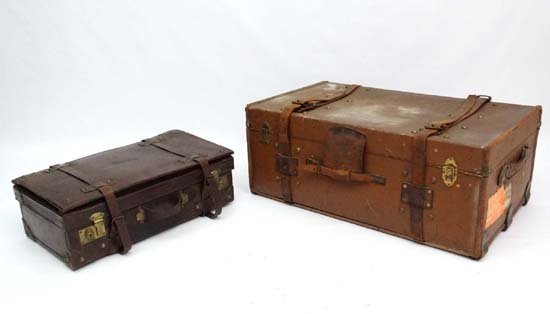 A c.1900 leather expandable case with linen lining and : A c.1900 leather expandable case with linen lining and leather straps together with a leather and brass bound brown leather travel trunk with badge for ' warranted flaxite fibre' the lid opening to re