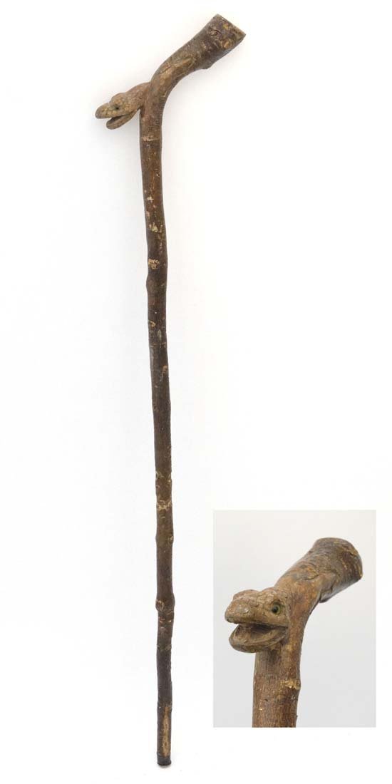 Walking Stick : A 19thC carved snakes head countryman's: Walking Stick : A 19thC carved snakes head countryman's rustic cane: well detailed with glass eyes, forked tongue to mouth and realistic scaled head.