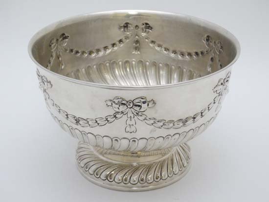 A silver pedestal rose bowl with bow, harebell and swag: A silver pedestal rose bowl with bow, harebell and swag decoration . Hallmarked London c.1904 maker Charles Stuart Harris. 7 1/4'' diameter x 4 3/4'' high (380g)