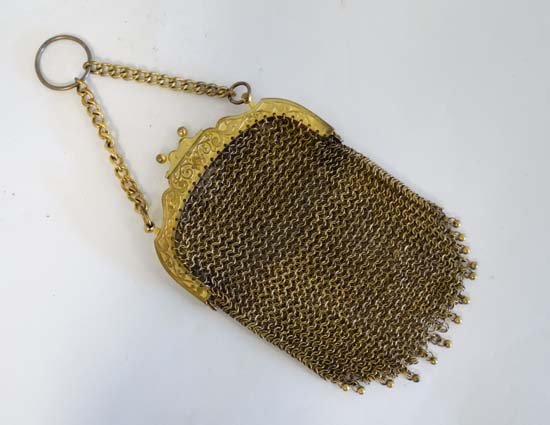 A c1900 Ladies gilt brass chain mail purse with finger: A c1900 Ladies gilt brass chain mail purse with finger ring, decorative detail to top of purse and push clasp opener. Approx 4'' wide.