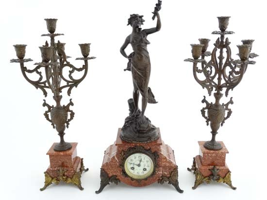 Clock and garniture set : a Rojo Alicante style marble: Clock and garniture set : a Rojo Alicante style marble cased 8 day clock with Marti movement no. 1886 31 , external count wheel striking on a bell, the case surmounted with a spelter figure entitled '