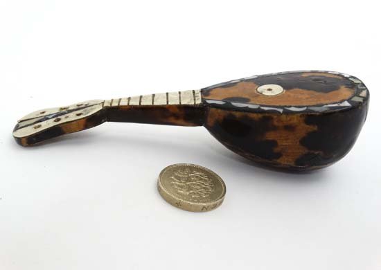 A c.1910 Neapolitan miniature mandolin with: A c.1910 Neapolitan miniature mandolin with tortoiseshell abalone etc 5'' long