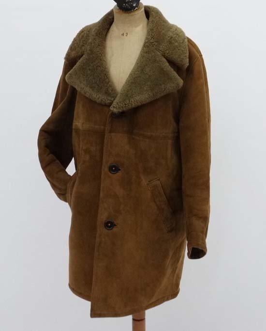 A ' Morlands ' made in England, real Lambskin (: A ' Morlands ' made in England, real Lambskin ( Sheepskin ) coat, having large collar, 2 front slit pockets and 3 large brown buttons.