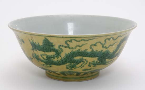 A Chinese bowl decorated with green 5 clawed green: A Chinese bowl decorated with green 5 clawed green dragons amongst clouds on a yellow ground , bears blue Chinese 6 character mark to base. 8 1/4'' diameter.