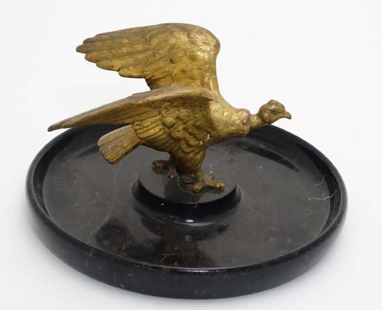 A gilt metal model of a Condor bird atop a circular (1 of 4)