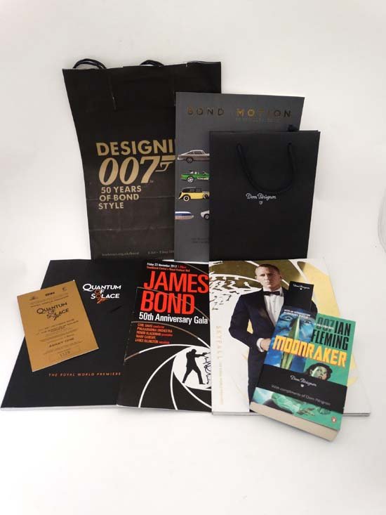Ephemera : A collection of James Bond memorabilia ,: Ephemera : A collection of James Bond memorabilia , comprising a copy of Ian Fleming's ' Moonraker ' within Dom Perignon and ' Designing Bond ' exhibition bags , a programme for the ' James Bond 50th