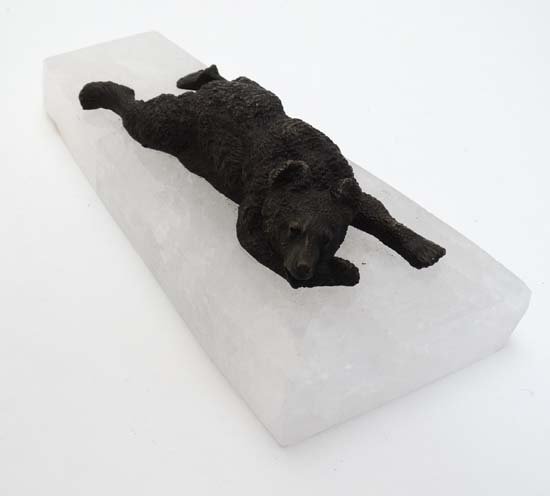 A cast bronze figure of a bear mounted upon a rock: A cast bronze figure of a bear mounted upon a rock crystal base 9'' long