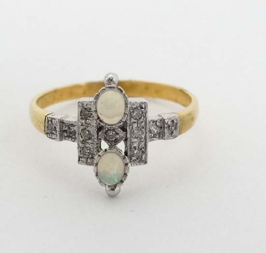 A silver gilt ring set with 2 opal like cabochon and: A silver gilt ring set with 2 opal like cabochon and white stones in an Art Deco style setting. Marked 'SIL'