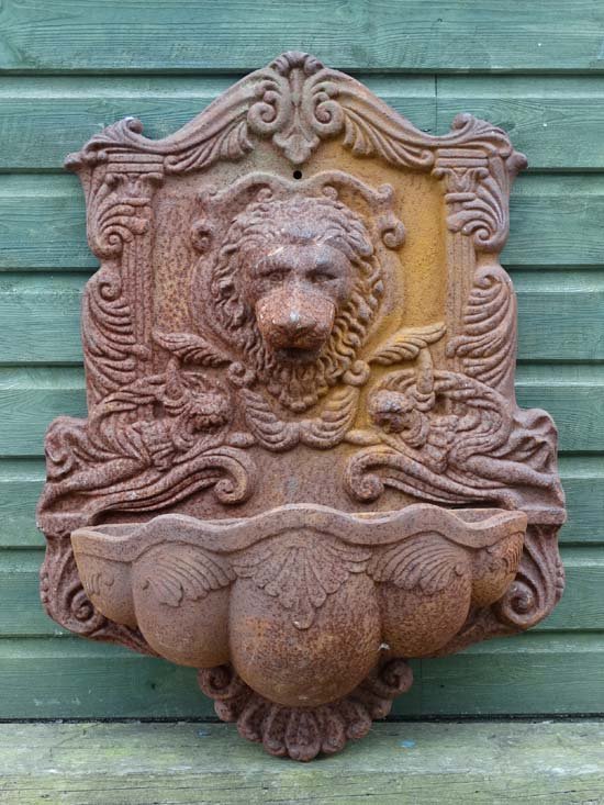 Garden & Architectural : an early - mid 20thC cast iron: Garden & Architectural : an early - mid 20thC cast iron wall mounted water fountain in the form of a lion's mask and reservoir. 31'' high