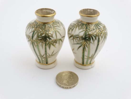 A pair of miniature satsuma style Japanese baluster: A pair of miniature satsuma style Japanese baluster vases, decorated in green with bamboo shoots and gilt highlights on a cream ground, bears Japanese seal mark to bases. 2 1/4'' high.