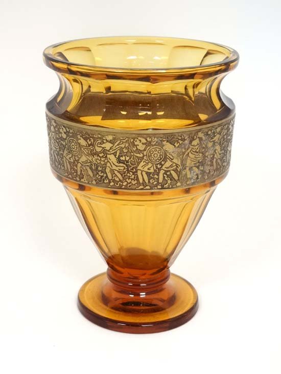 Moser Glass : An Amber glass vase with band of gilded: Moser Glass : An Amber glass vase with band of gilded decoration depicting warriors with spears and shield. Signed under ' Made in Cecho Slovakia Moser Karlsbad' . Approx 6 1/4'' high