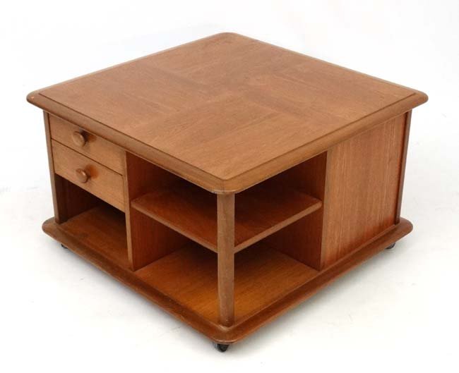 Vintage Retro : A British Teak coffee table similar to: Vintage Retro : A British Teak coffee table similar to Ercol's Pandoras Box Occasional table with 2 sets of 2 drawers and 2 shelves and quatered grained top, 18'' high x 29 3/4'' sq.