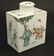A Chinese famille rose tea caddy decorated in