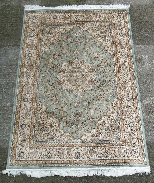 Carpet / Rug : A machine made prayer rug , in the: Carpet / Rug : A machine made prayer rug , in the Aubusson style , with a central ground of sage green with black, gold, buff colours with a double thin banded single wide band , 52 x 80''.
