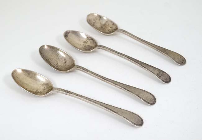 A set of 4 silver feather edged teaspoons hallmarked: A set of 4 silver feather edged teaspoons hallmarked Sheffield 1921 maker Harrison Brothers & Howson 4 1/4'' long (56g)