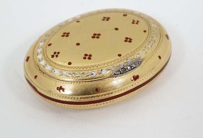 18 Ct Gold pill box : an engine turned oval hinge: 18 Ct Gold pill box : an engine turned oval hinge lidded pill box with diamond and red enamel inlaid decoration opening to reveal hallmark for maker Wright & Davies ( William Frederick Wright ) London