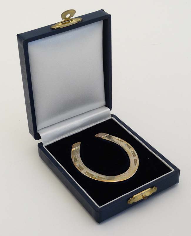 A silver miniature model of a horseshoe. Hallmarked: A silver miniature model of a horseshoe. Hallmarked Sheffield 2004 maker Francis Howard (30g) 2 1/2'' high ( in presentation case)