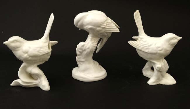 A Crown Staffordshire model of a blue tit in white: A Crown Staffordshire model of a blue tit in white gloss finish , having factory stamp to base, together with two ceramic models of wrens upon branches, unmarked. The tallest 3 1/2'' high.