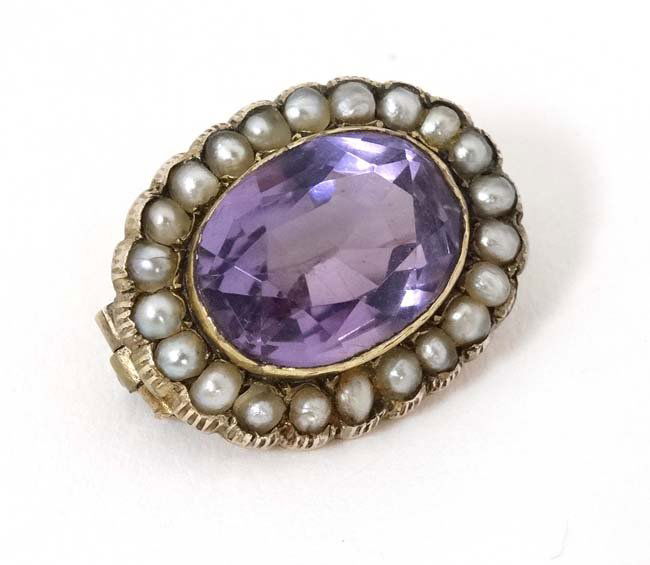 A gilt metal brooch set with central amethyst bordered (1 of 4)