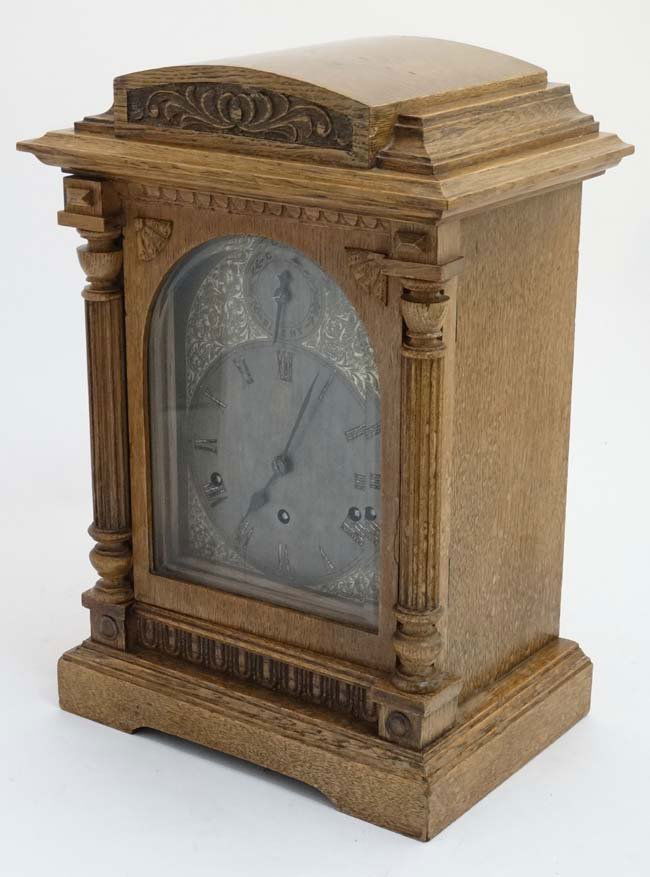 3 Train Musical Clock : an oak cased c. 1900 3 train: 3 Train Musical Clock : an oak cased c. 1900 3 train Bracket clock , the arch shaped silvered and engraved 6 3/4'' wide dial having a movement striking on the 1/4 hour , standing 17'' high x 11 1/2''