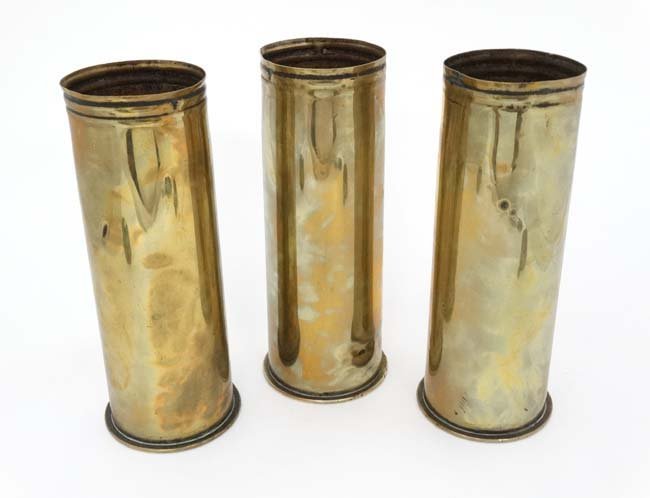 Militaria : A collection of three WWI Imperial German: Militaria : A collection of three WWI Imperial German Army Feldcanone shell casings (inert) , bearing headstamps for Geschossfabrik Spandau Jan 1914 , Friedrich Niemeyer Aug 1917 and Haniel Luege Düs