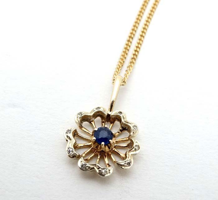 A sapphire and diamond pendant on a 20'' 9ct gold chain: A sapphire and diamond pendant on a 20'' 9ct gold chain