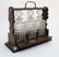 A late 19thC / early 20thC 3- bottle oak Tantalus with - 3