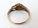 An 18ct gold ring set with central sapphire bordered by - 4
