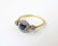 An 18ct gold ring set with central sapphire bordered by - 6