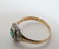A 15ct gold ring set with central emerald bordered by - 3