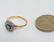 A 15ct gold ring set with central emerald bordered by - 4