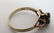 A gold ring set with dark semi-precious stone flaked by - 3