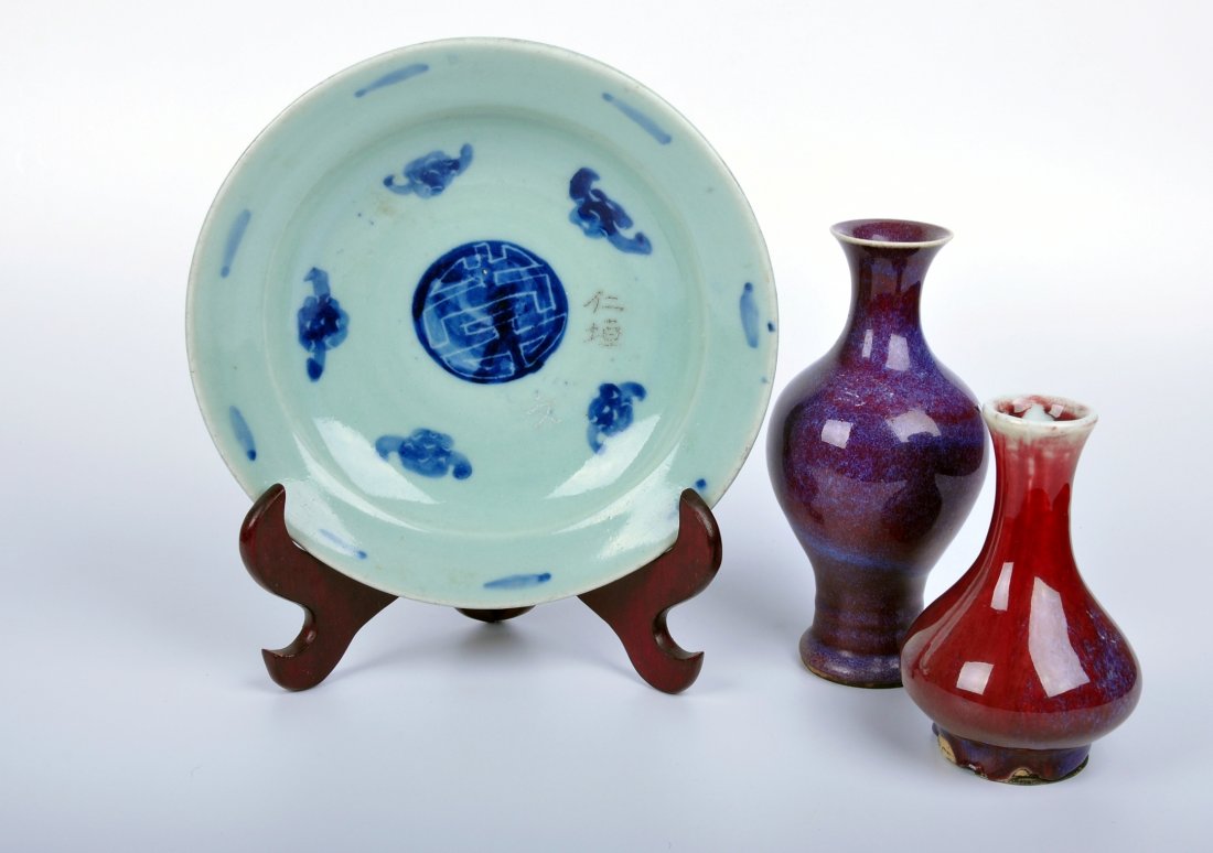A Assorted of Three Porcelain Wares, Qing Dynasty: 清 瓷器三件 comprising a blue and white dish decorated with five bats and a symbol, a flambe-glazed bottle vase with a rich sang-de-boeuf glazed firing to purple tones, a