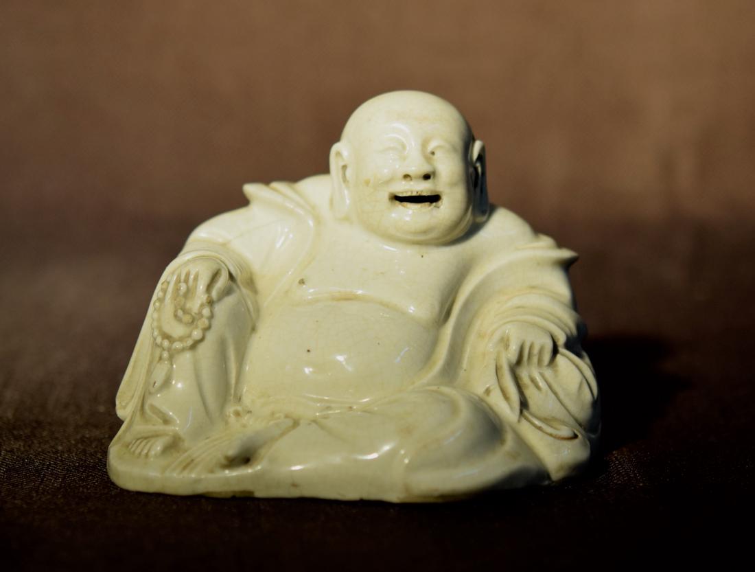 Chinese Zhang Zhou Kiln Porcelain Happy Buddha: 18/19th cen, with small glaze chip on the buddhist bead, measures 5.5" w 4" in height