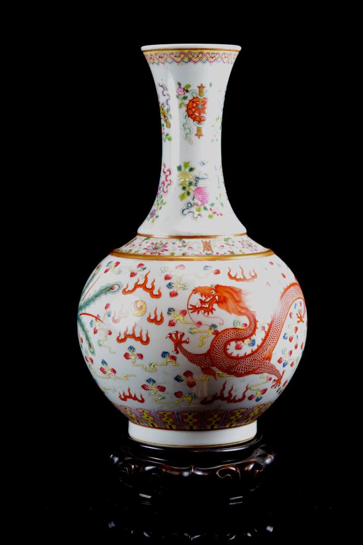 Chinese Porcelain Vase with Dragon Pheonix Motif: 20th cen, with rosewood base, gaunxu mark in underglazed blue, dragon and pheonix motif, measures 16" for the vase; Provenace: from a Boston Area Collection