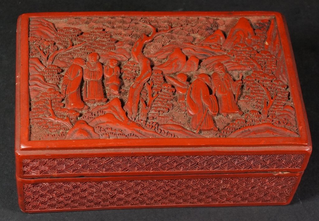 Chinese Carved Cinnabar Box: Of scholars in garden scene, 19th century. Measures 7.5" by 4.5".